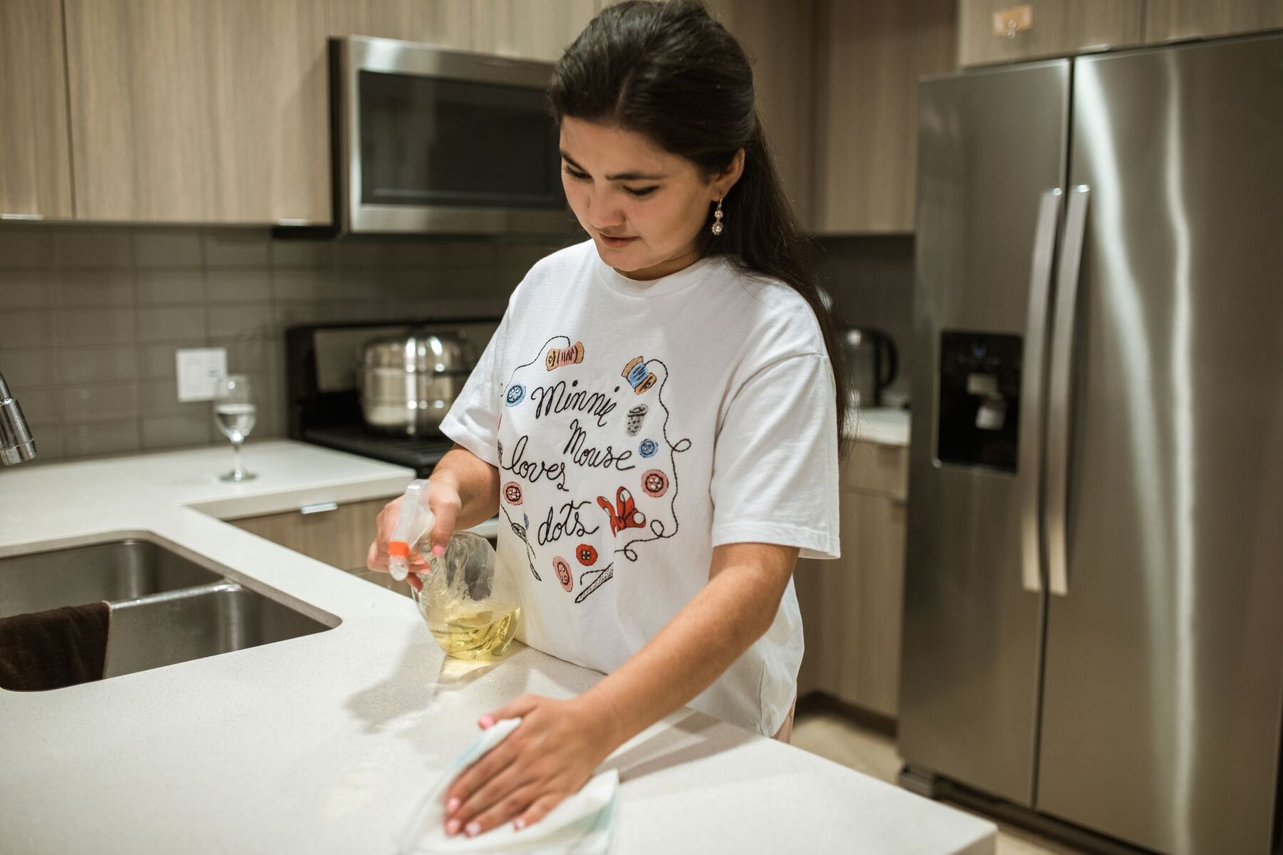 Kitchen counters being wiped down during a regular house clean